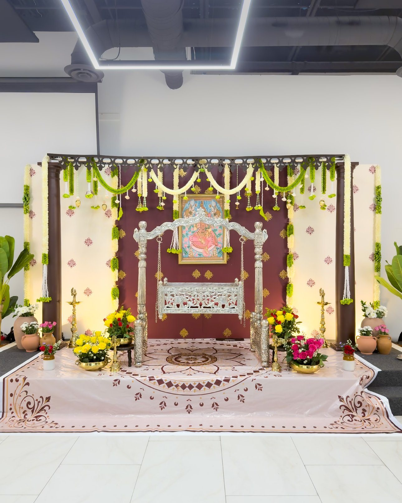 Silver cradle framed by ceremony décor