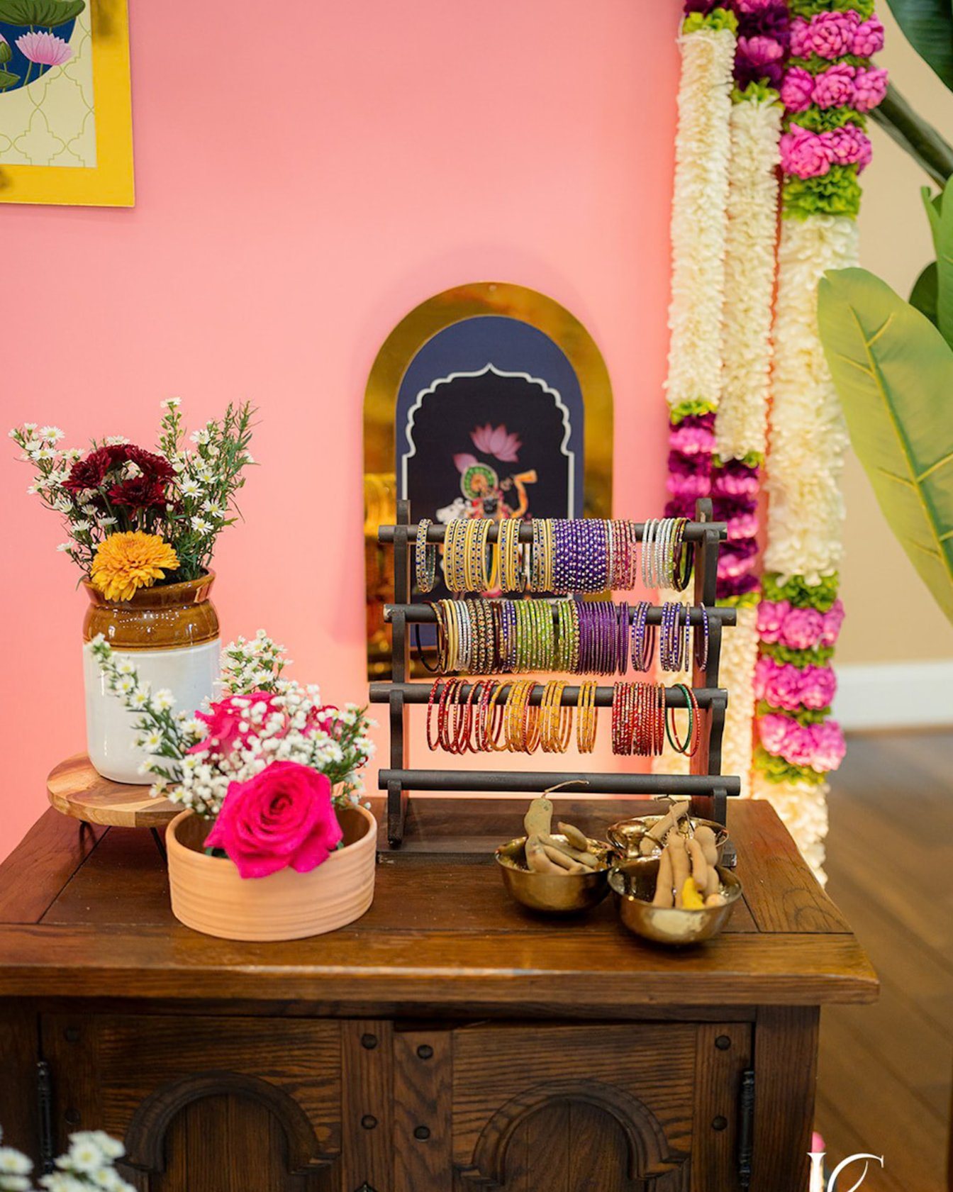 Bangle stand styled against a pink floral wall