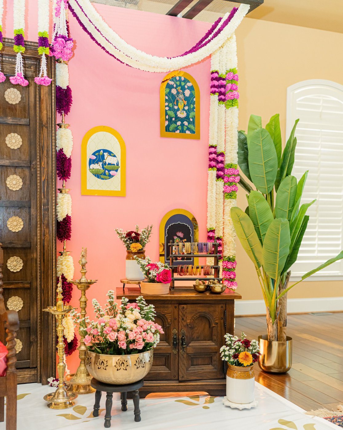 Styled cabinet beside a pink ceremony wall