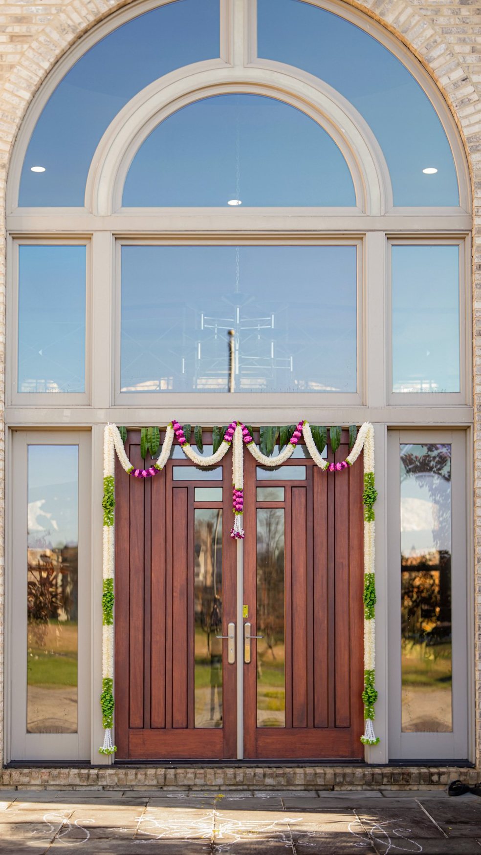 Floral entrance framed by open doors