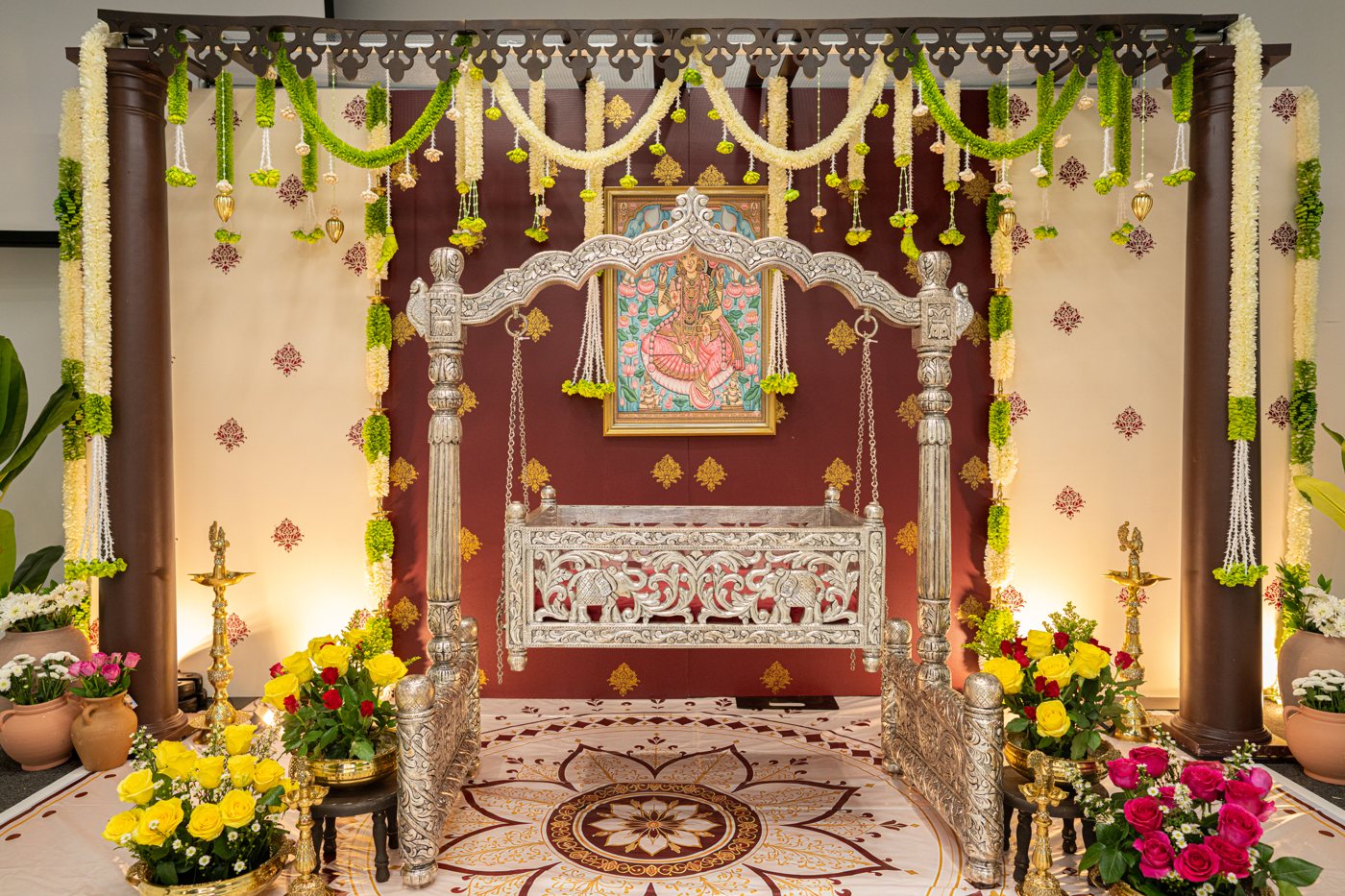 Silver cradle close-up with floral ceremony details