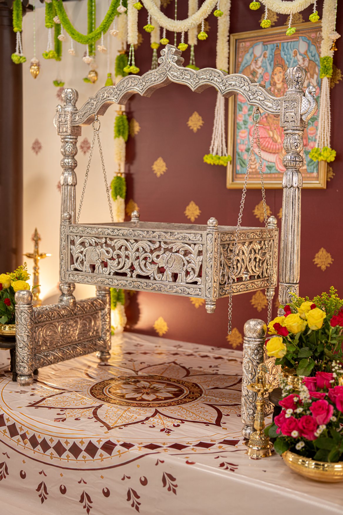 Angled close-up of an ornate silver cradle
