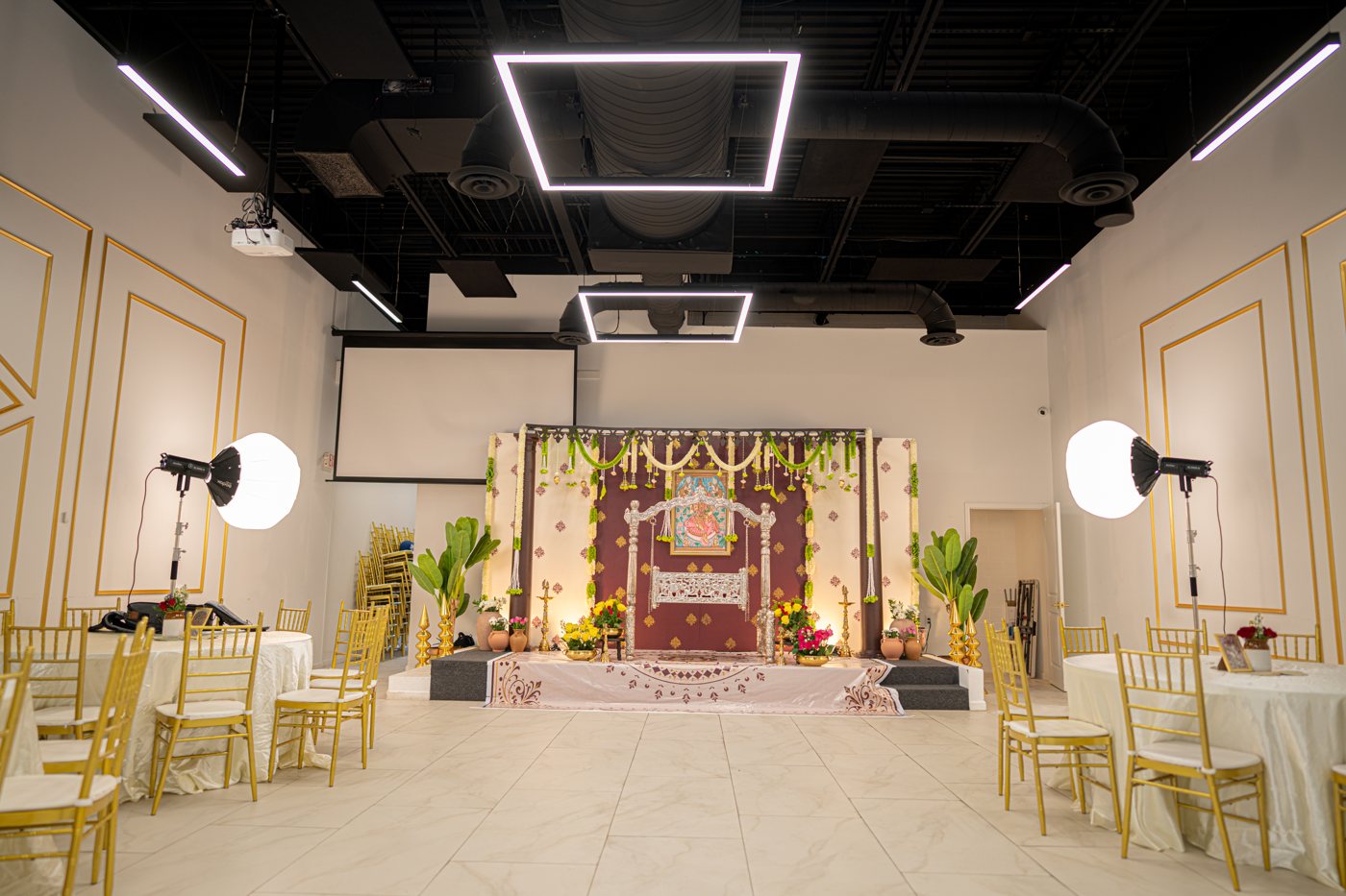 Wide venue view with a decorated cradle ceremony stage