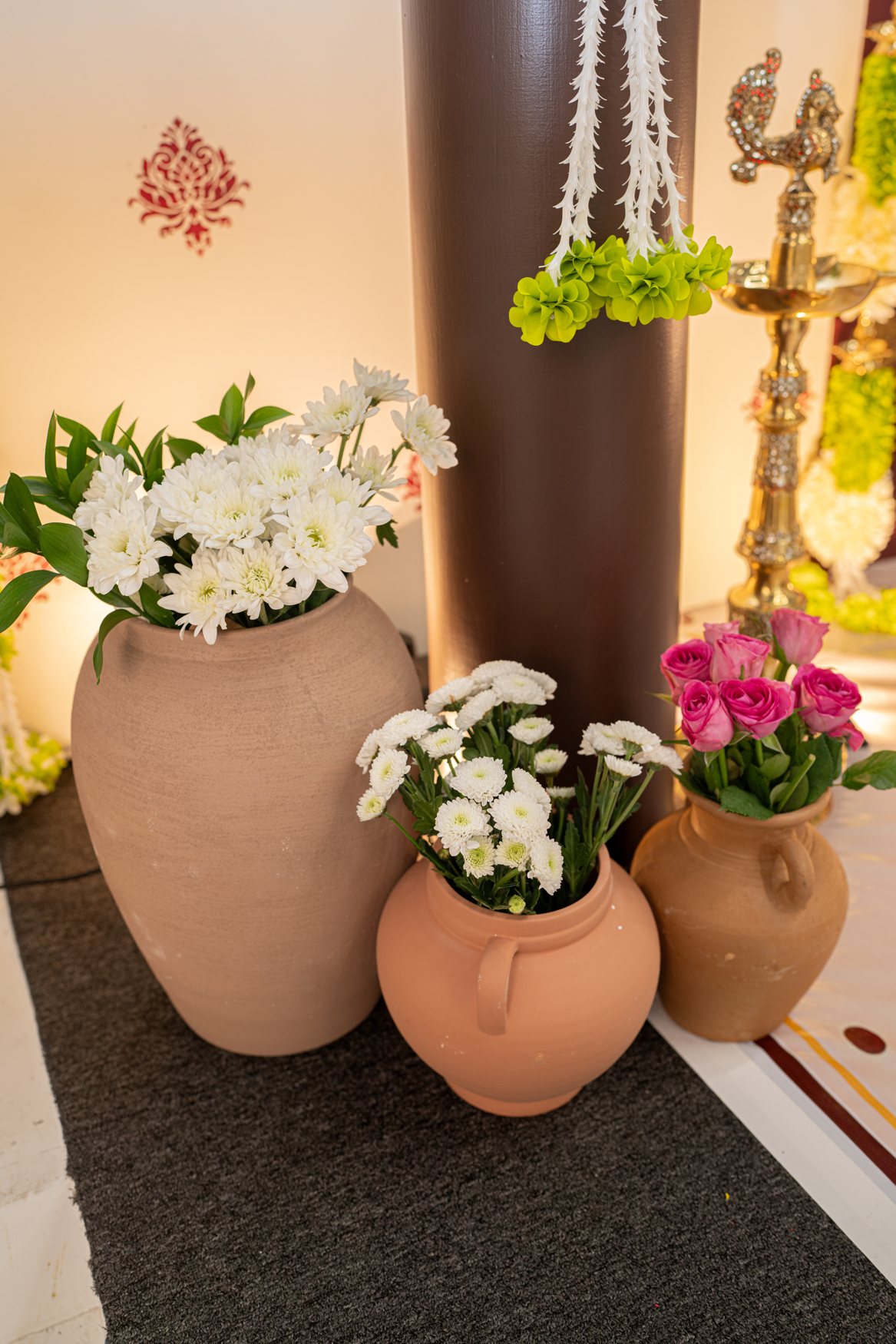 Terracotta pots arranged with fresh flowers